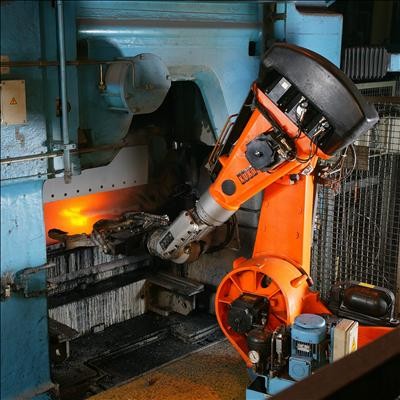 An industrial robot arm working at a foundry
