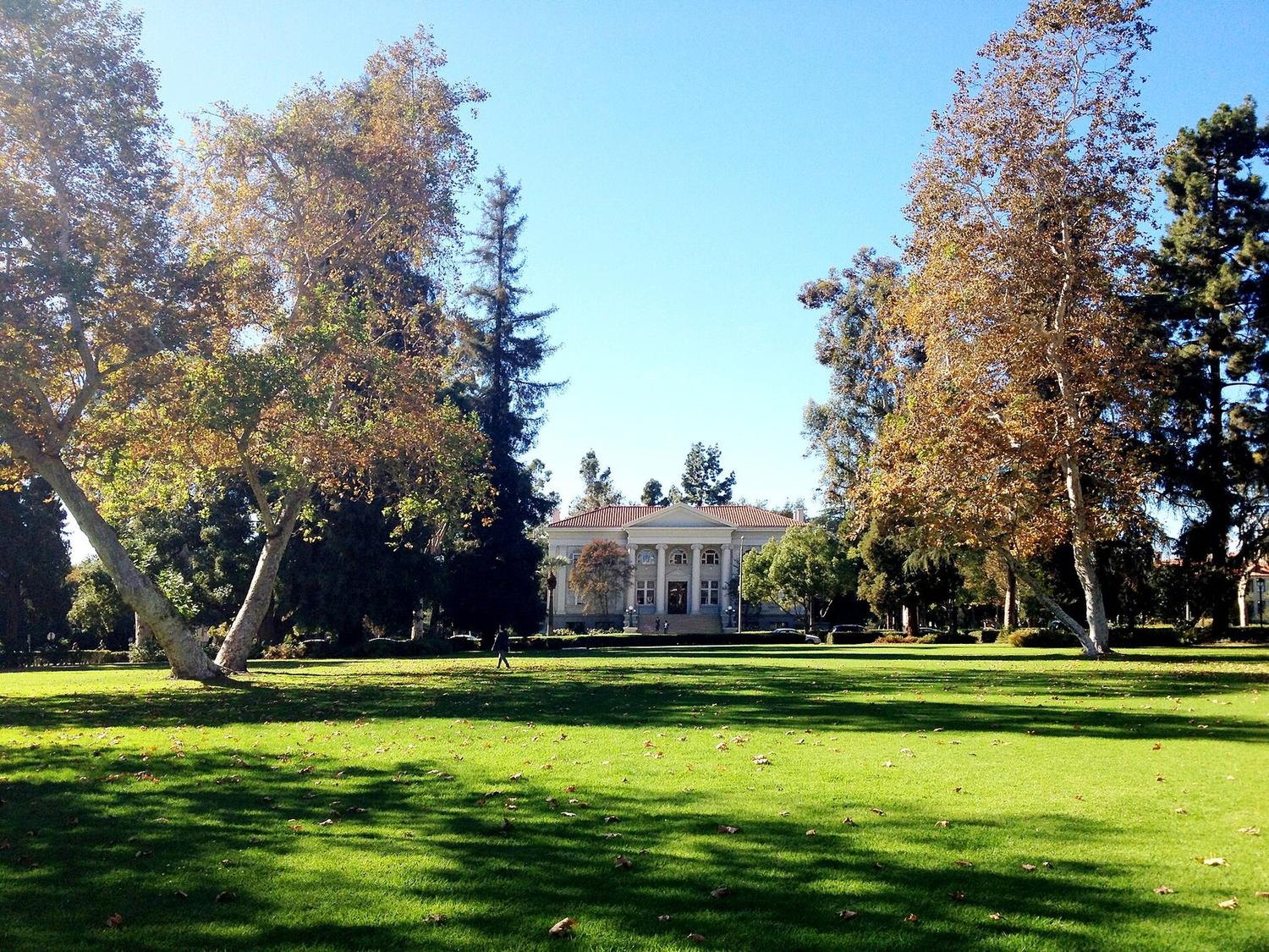 A quiet college campus quad with a lone figure walking