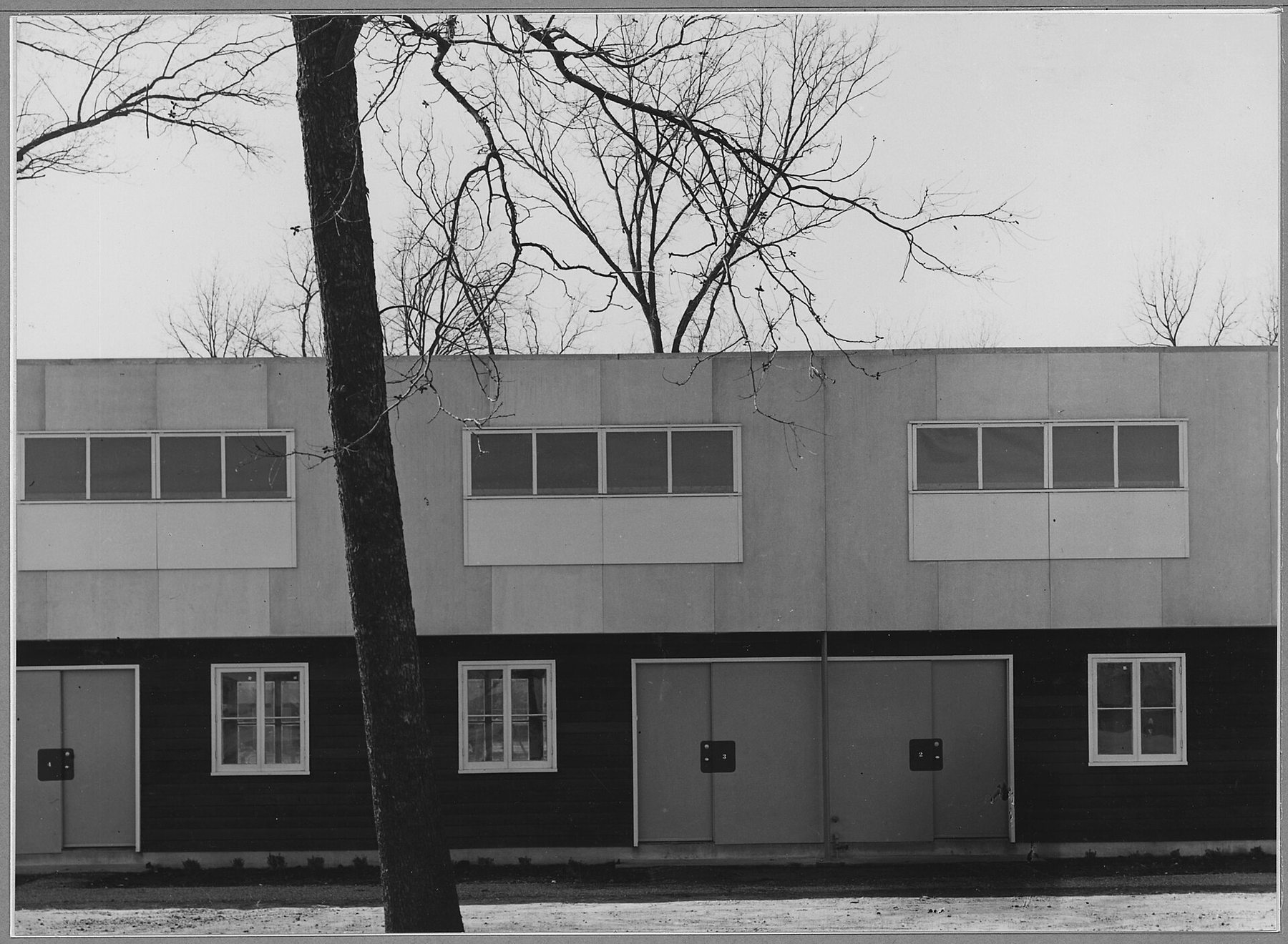 A row of numbered doors on a multi-family dwelling