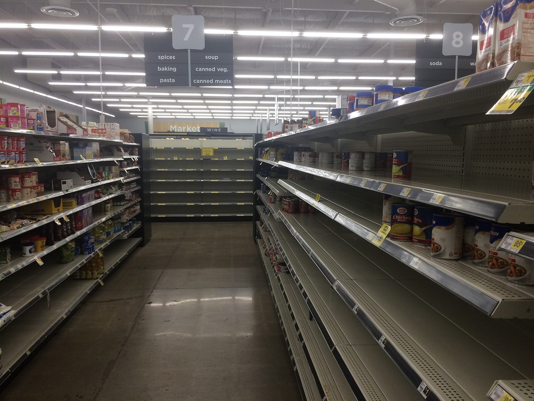 Nearly empty grocery store shelves in the canned goods aisle