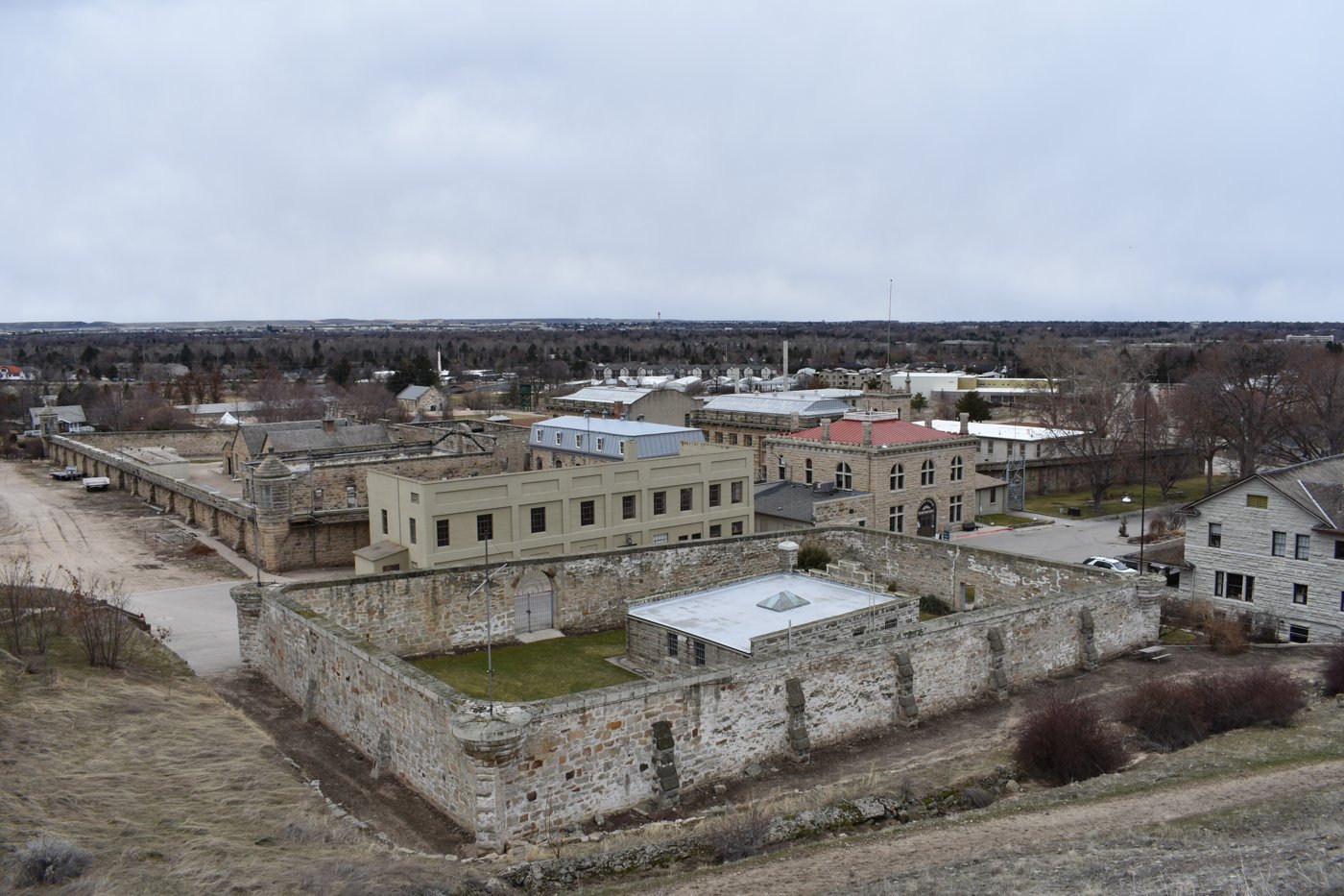 Aerial view of a historic state penitentiary compound with high stone walls