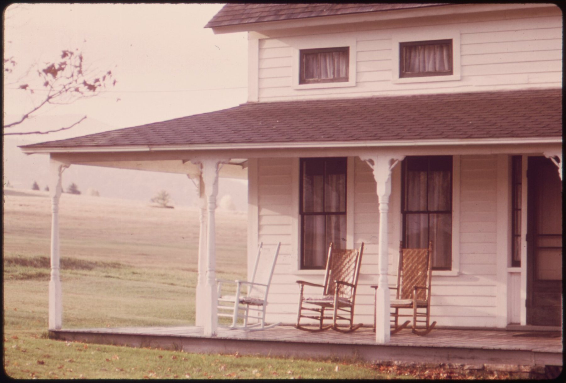 Empty rocking chairs on an old farmhouse porch