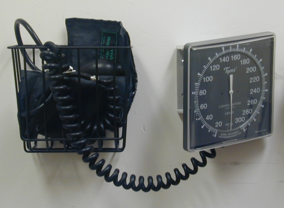 A blood pressure gauge mounted on an exam room wall