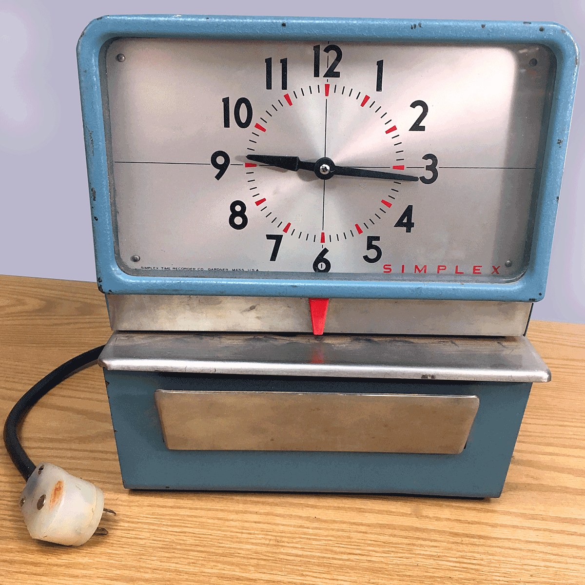 A vintage American workplace time-recorder punch clock